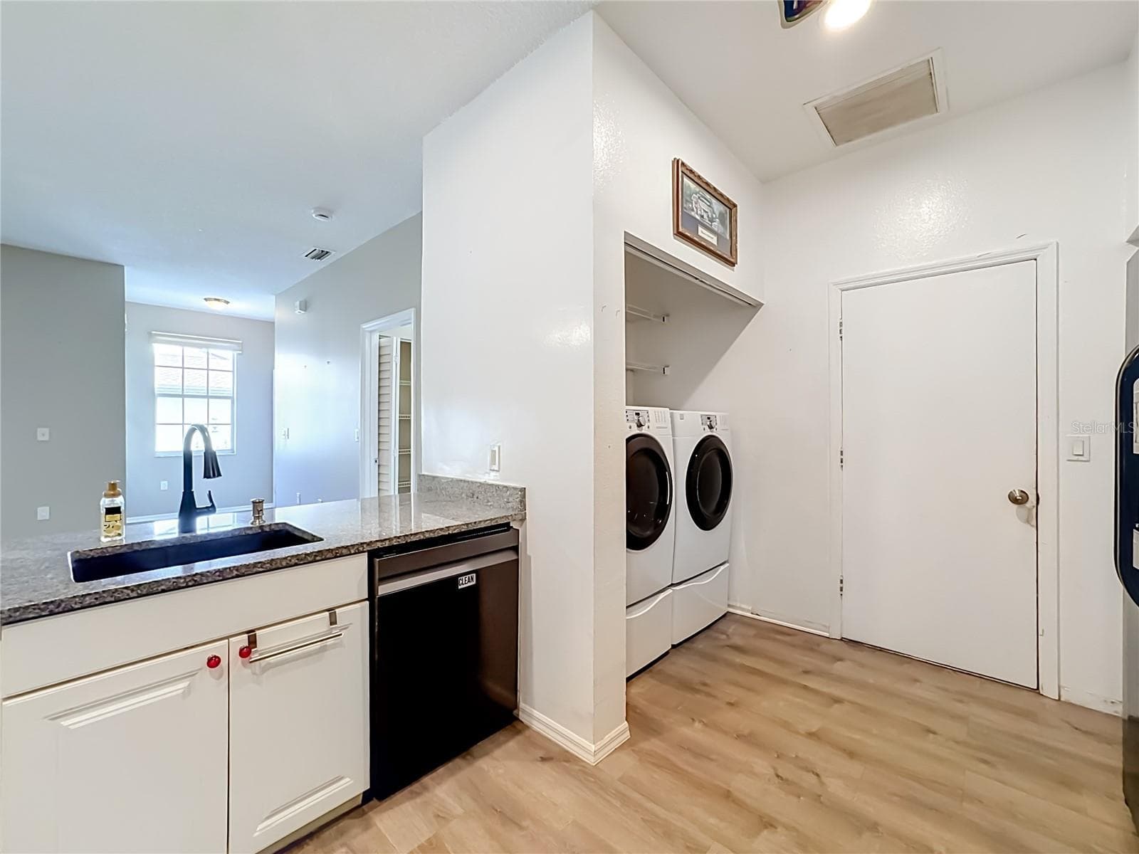 Full size front loading washer and dryer in kitchen. - 3308 60TH AVE W, BRADENTON