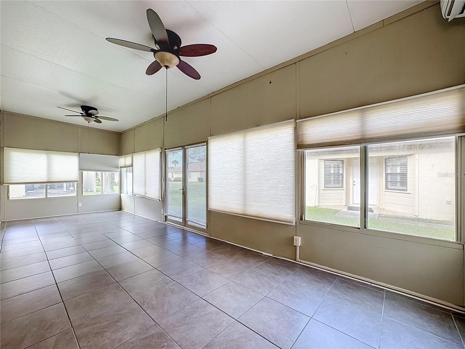 Two ceiling fans and the mini split AC offer lots of comfort for this flex room. - 3308 60TH AVE W, BRADENTON