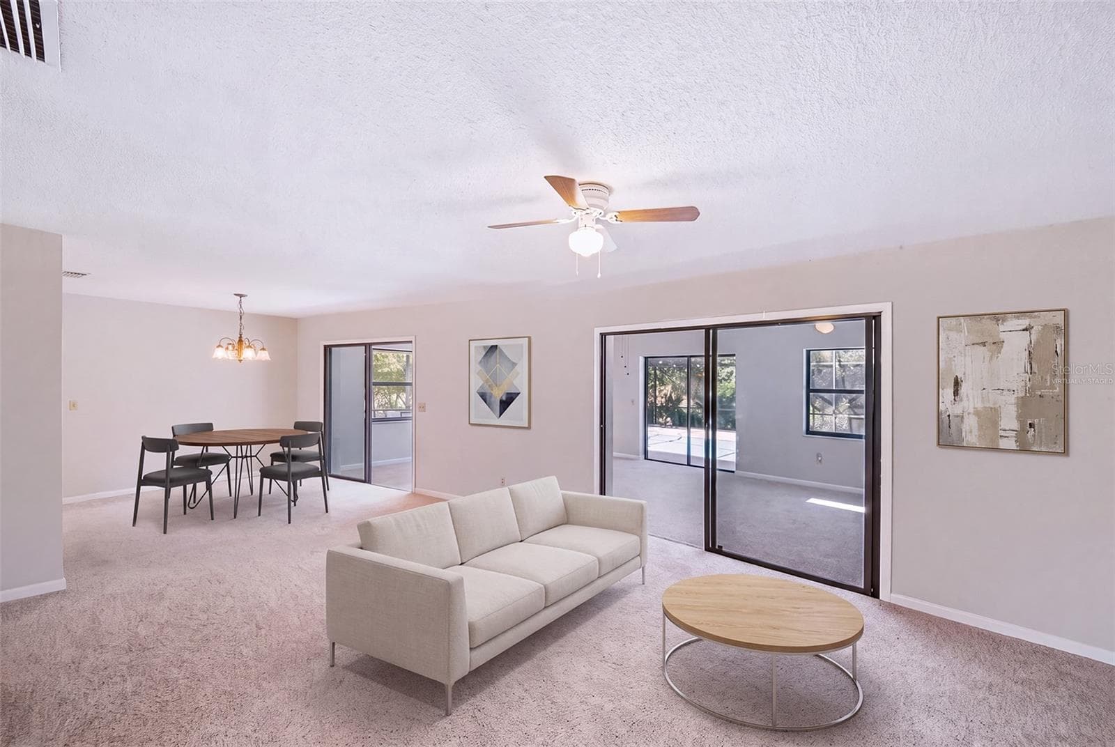 Virtually staged with furniture in dinette/living room area - 83 FARRAGUT DR, PALM COAST