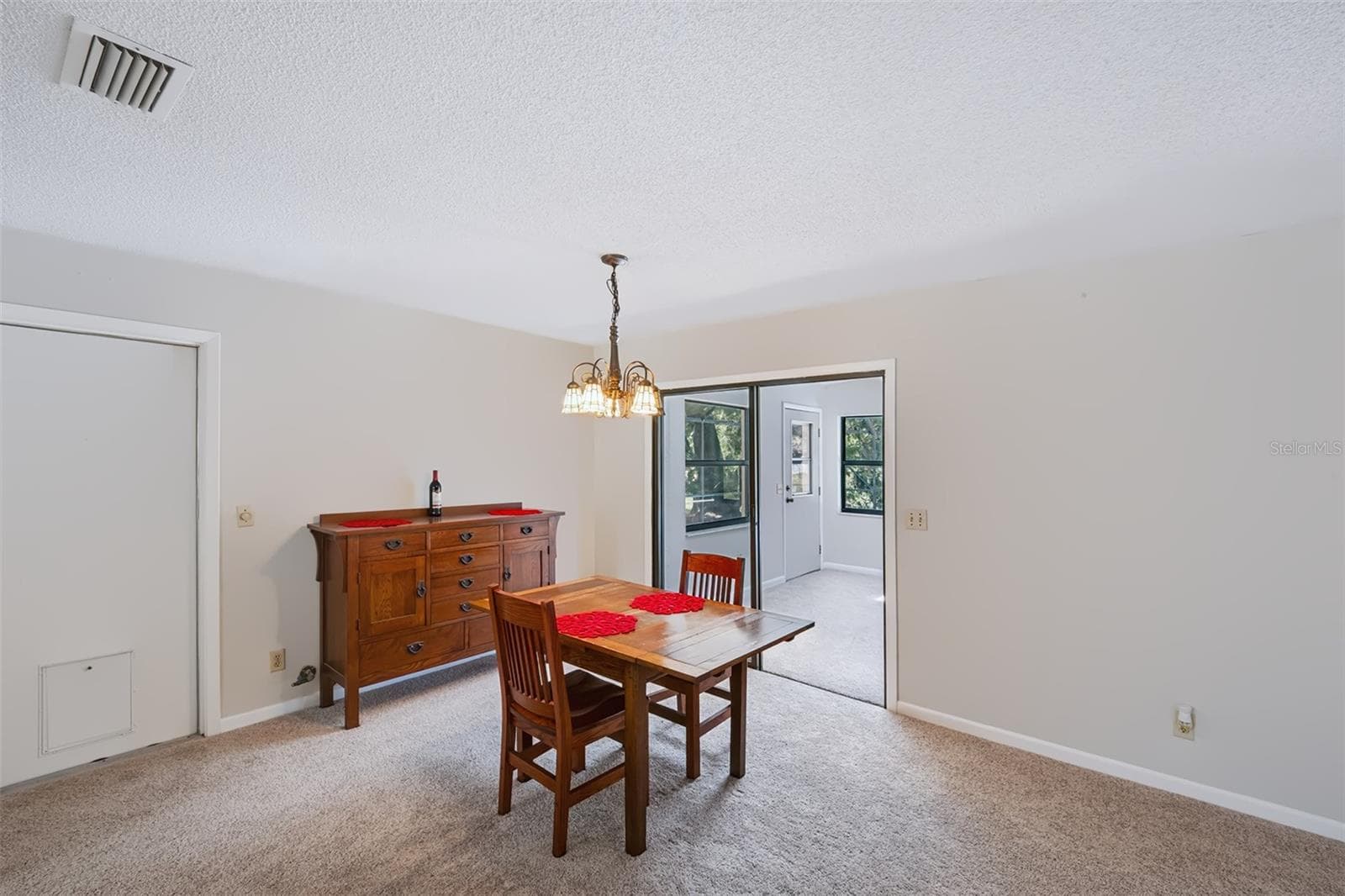 Sliding glass door entry into the Florida room from dinette - 83 FARRAGUT DR, PALM COAST