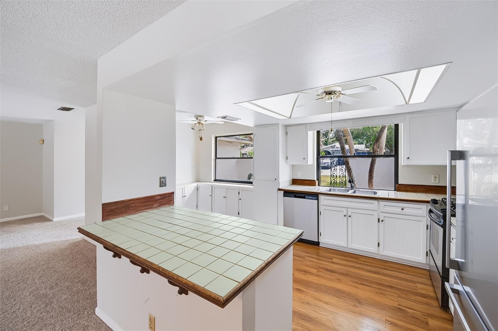 View from the dinette small breakfast bar area into the kitchen - 83 FARRAGUT DR, PALM COAST