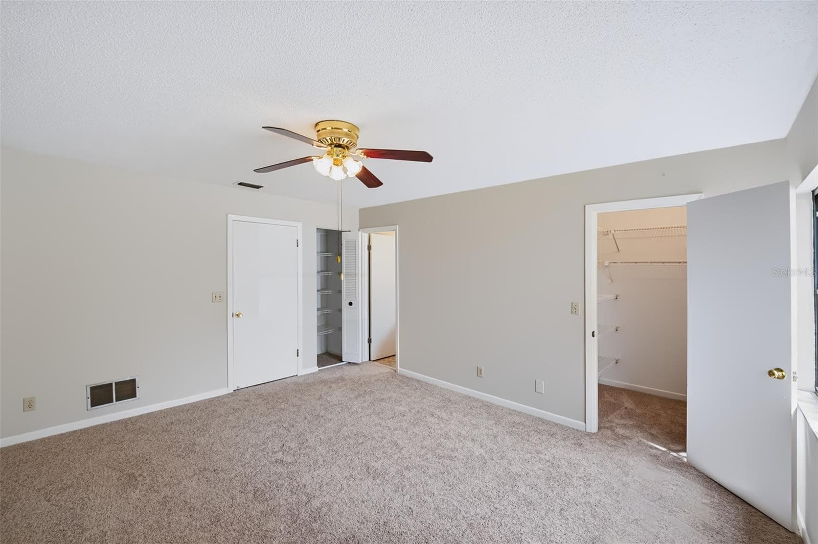 Master bedroom displaying the walk-in closet, and linen closet just outside the master bathroom - 83 FARRAGUT DR, PALM COAST