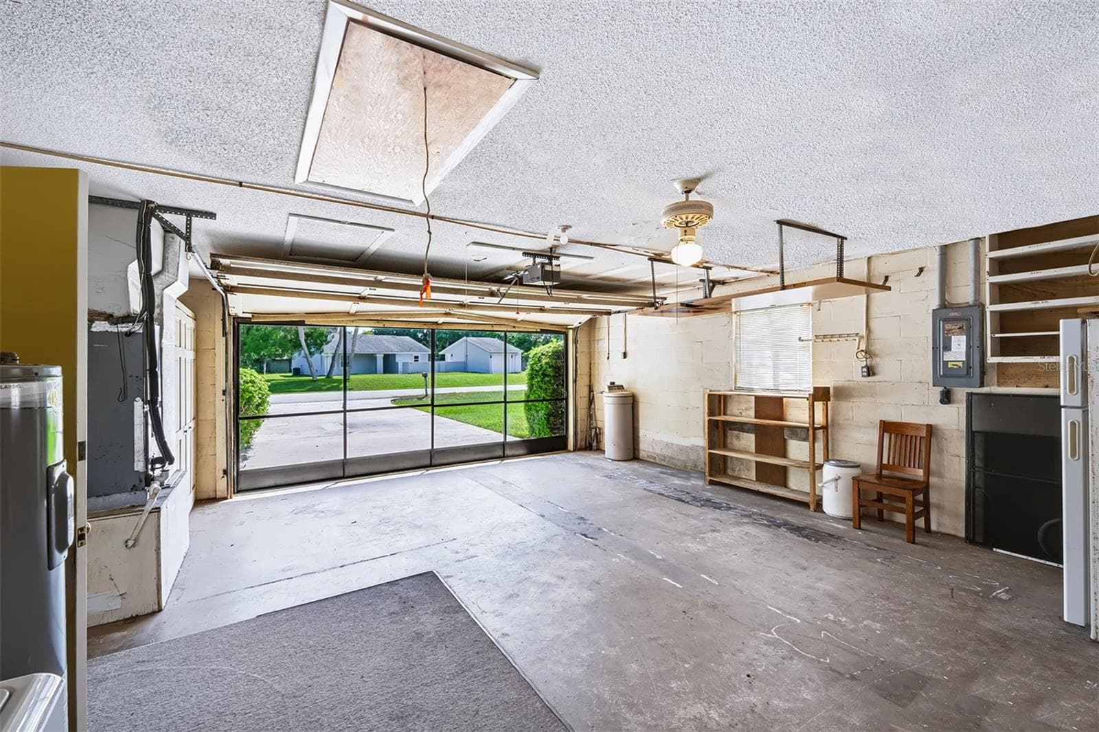 View of garage exiting door from dinette area. This shows the sliding screen doors in use with the garage door open - 83 FARRAGUT DR, PALM COAST