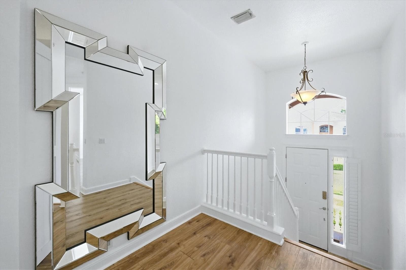 foyer, stairs lead up to main living area, and down to garage and storage closets - 5458 46TH CT W, BRADENTON