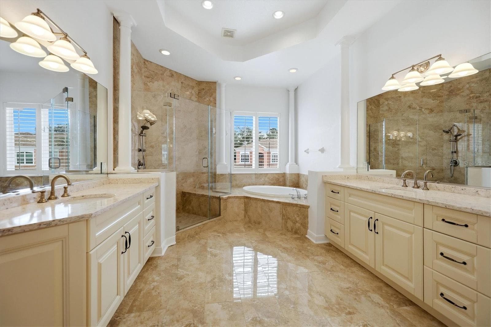 master bathroom with large vanities, walk in shower, garden soaking tub, blonde cabinets and stone counters - 5458 46TH CT W, BRADENTON
