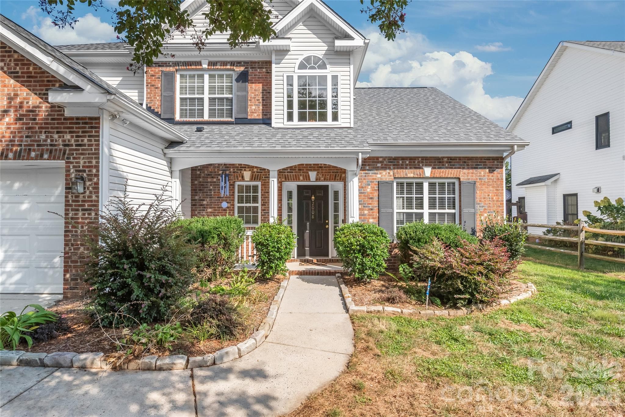 Start your mornings with a cup of coffee on the charming covered front porch...the ultimate spot to relax. - 2008 Trace Creek Drive, Waxhaw