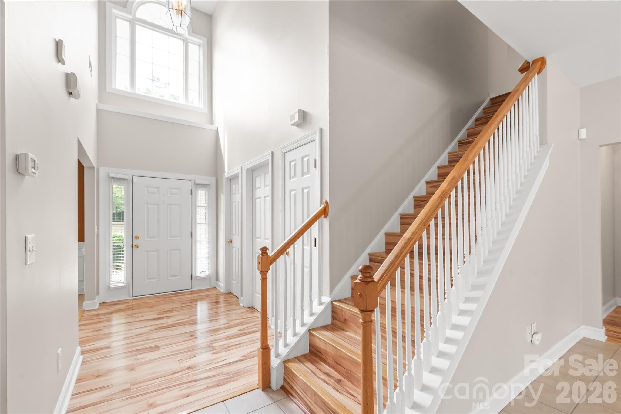 Make a grand first impression in the dramatic two-story foyer, where soaring ceilings and rich natural light set a bright, airy tone the moment you step inside. - 2008 Trace Creek Drive, Waxhaw