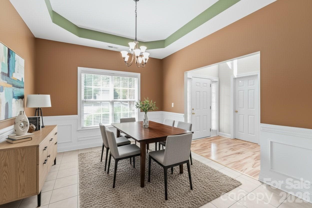 Located right off the grand entry, the formal dining room makes a sophisticated statement with elegant wainscoting and a dramatic trey ceiling. Virtually Staged. - 2008 Trace Creek Drive, Waxhaw