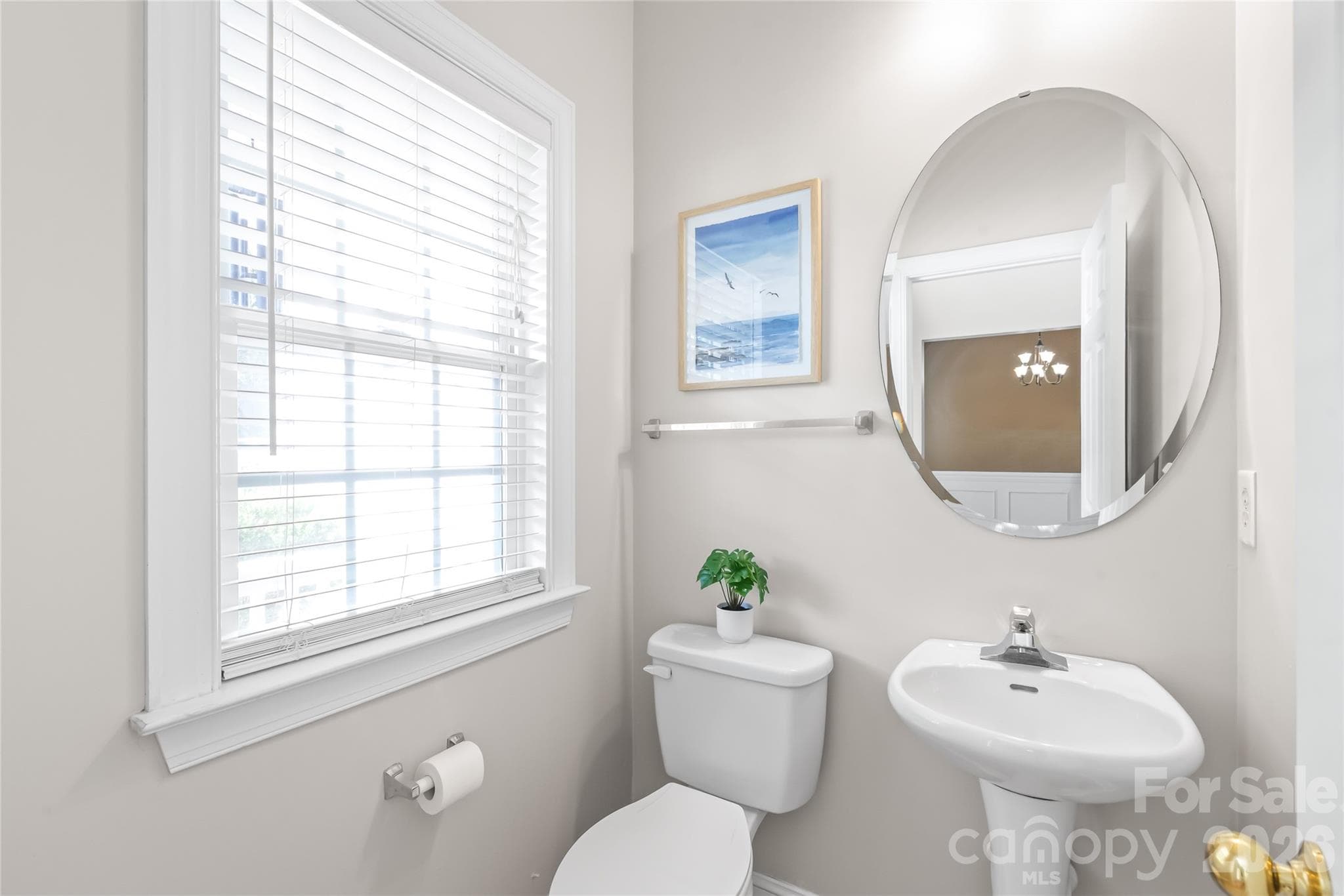 Conveniently located on the main level for guests, the charming powder room features a classic pedestal sink. - 2008 Trace Creek Drive, Waxhaw