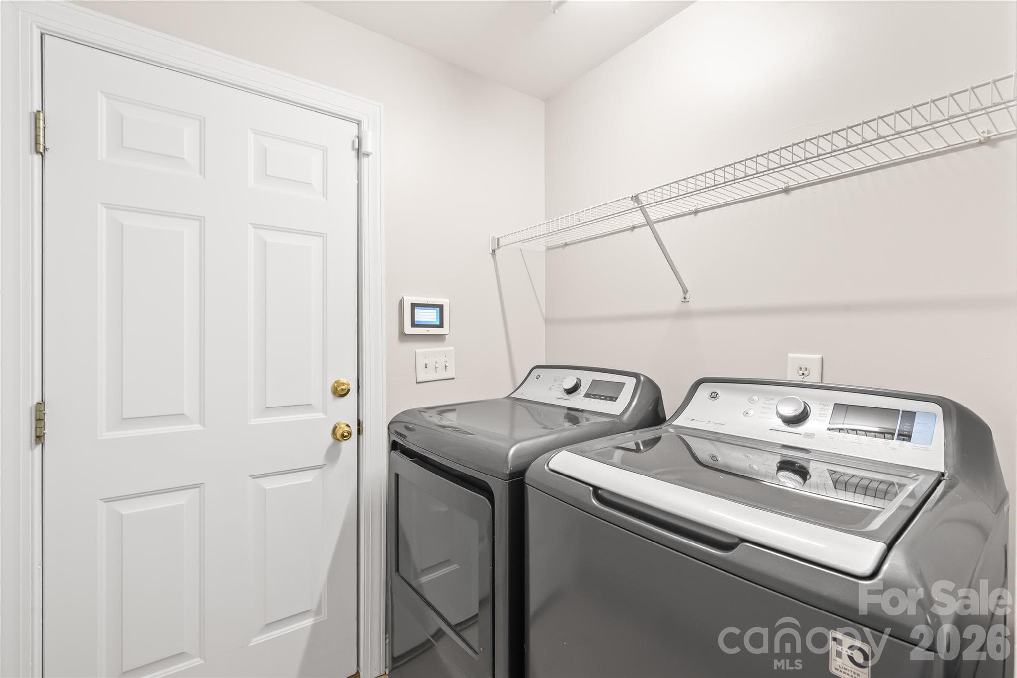Conveniently located on the main floor right off the 2-car garage, the dedicated laundry room doubles as a practical drop zone to keep outer gear and daily clutter effortlessly out of sight. - 2008 Trace Creek Drive, Waxhaw