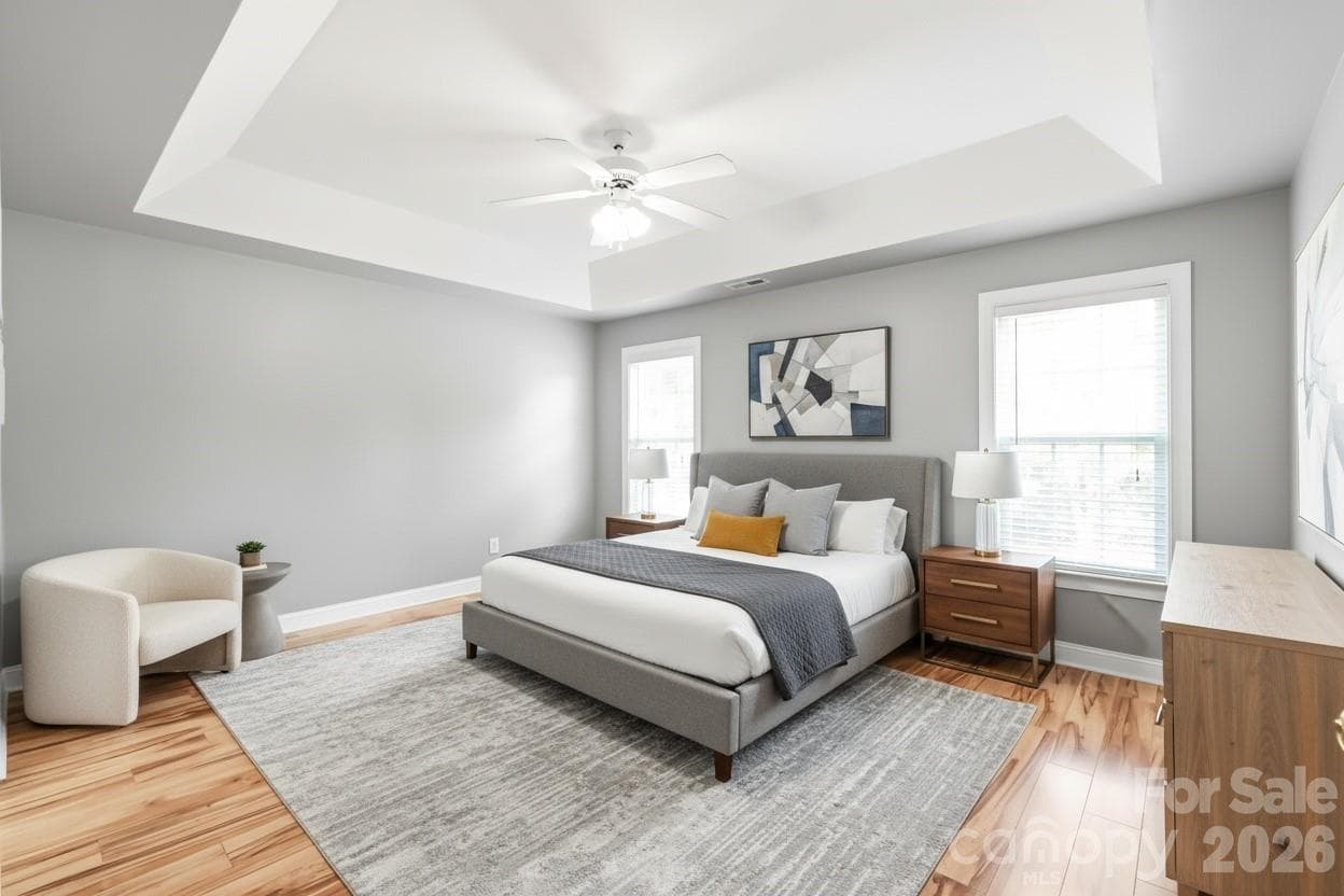 Showcasing elegant trey ceilings and durable LVP flooring, the primary bedroom is a peaceful retreat designed for effortless comfort and relaxation. Virtually Staged. - 2008 Trace Creek Drive, Waxhaw