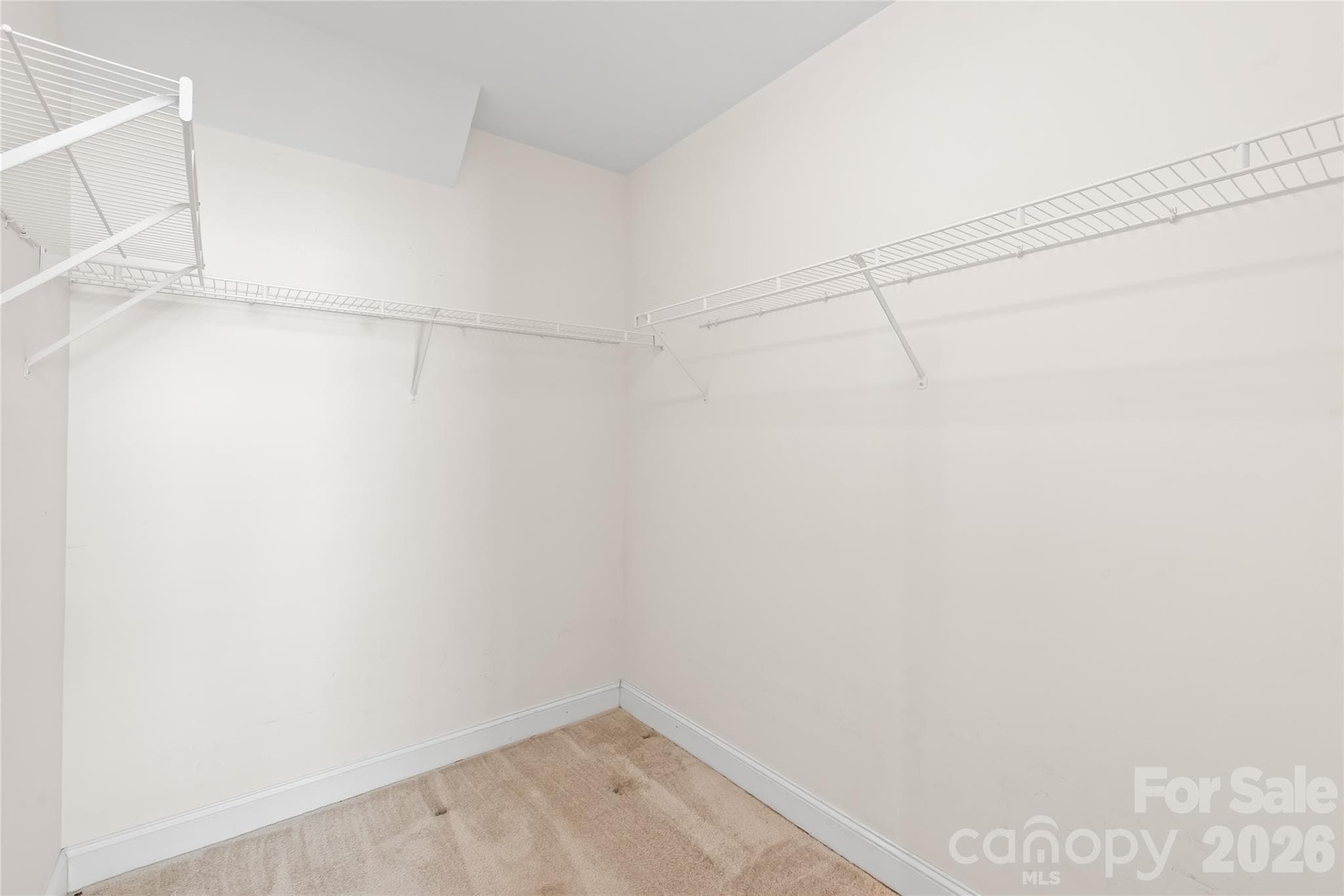The primary suite features a spacious walk-in closet keeping your wardrobe organized and within easy reach. - 2008 Trace Creek Drive, Waxhaw