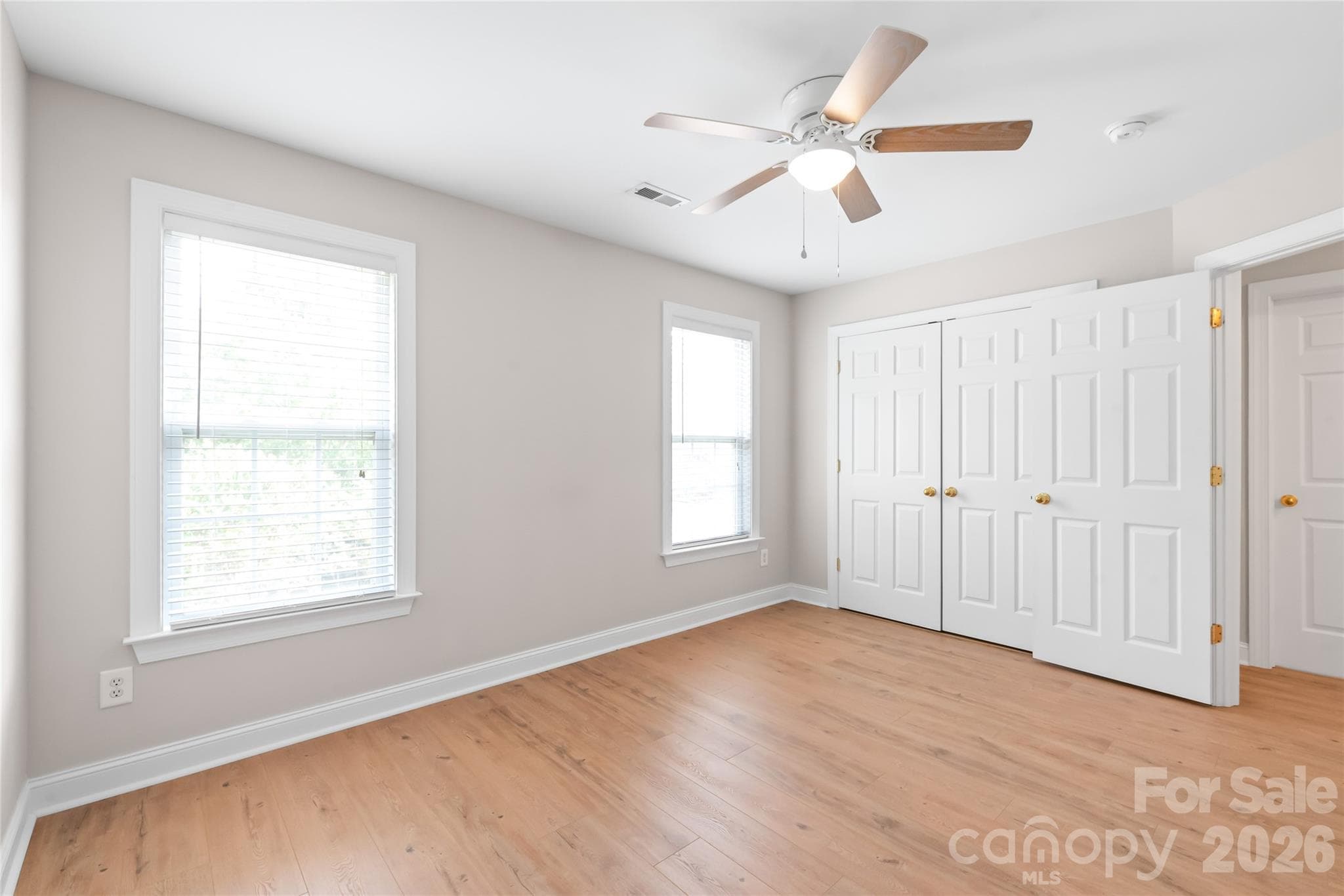 Bedroom 4 features beautiful LVP flooring and a ceiling fan, making it an ideal space for a guest room, dedicated home office, or cozy bedroom retreat. - 2008 Trace Creek Drive, Waxhaw
