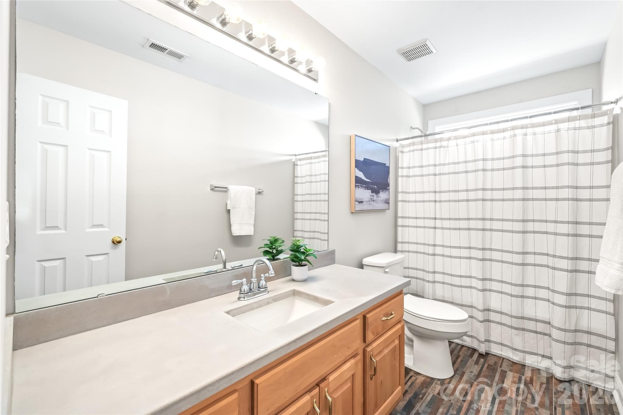 The second upstairs full bath boasts updated countertops and a new sink, paired with tub/shower combo. - 2008 Trace Creek Drive, Waxhaw