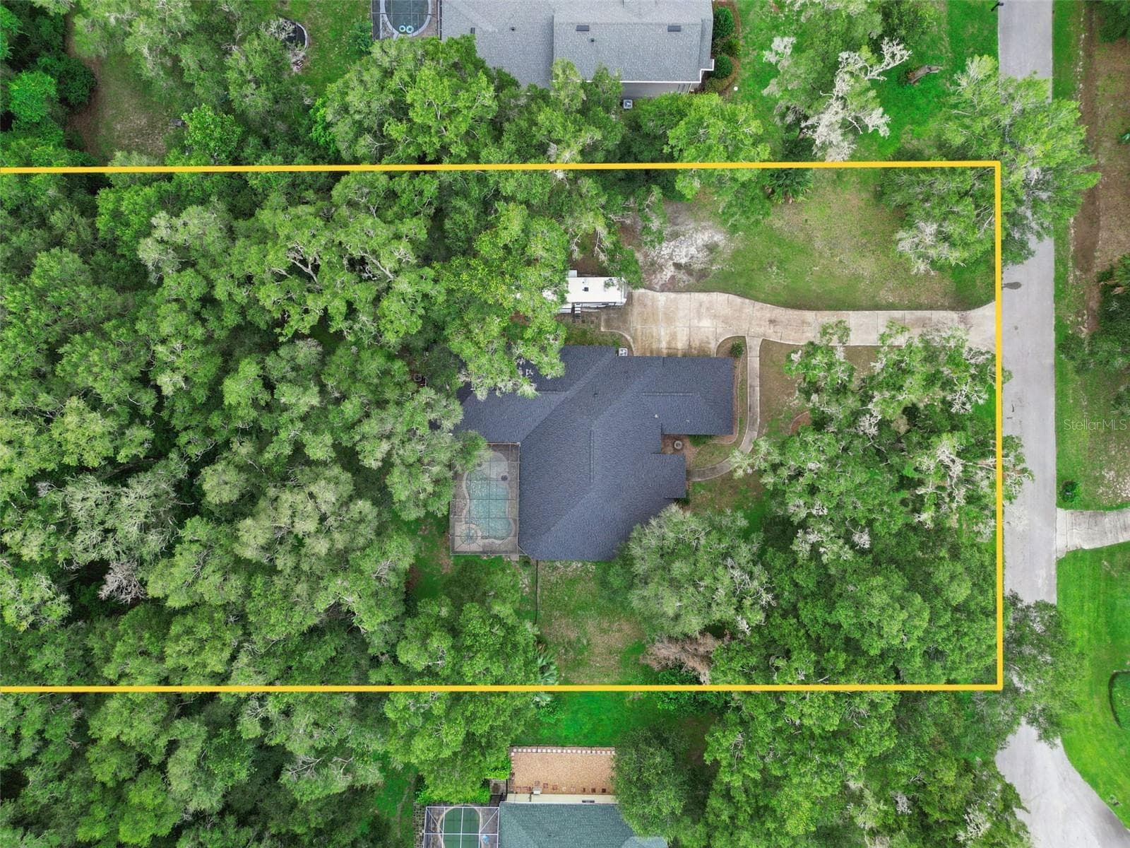 Overhead aerial provides perspective on the home, pool enclosure and surrounding land. - 30440 JUBILEE WAY, SORRENTO