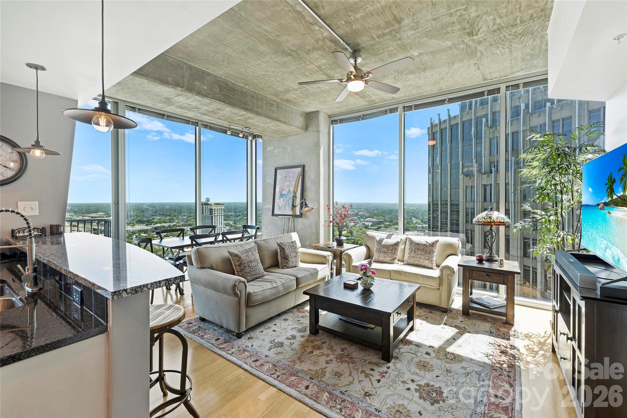 Corner living room showcases the height, light and views of #3415 - 210 N Church Street, Charlotte