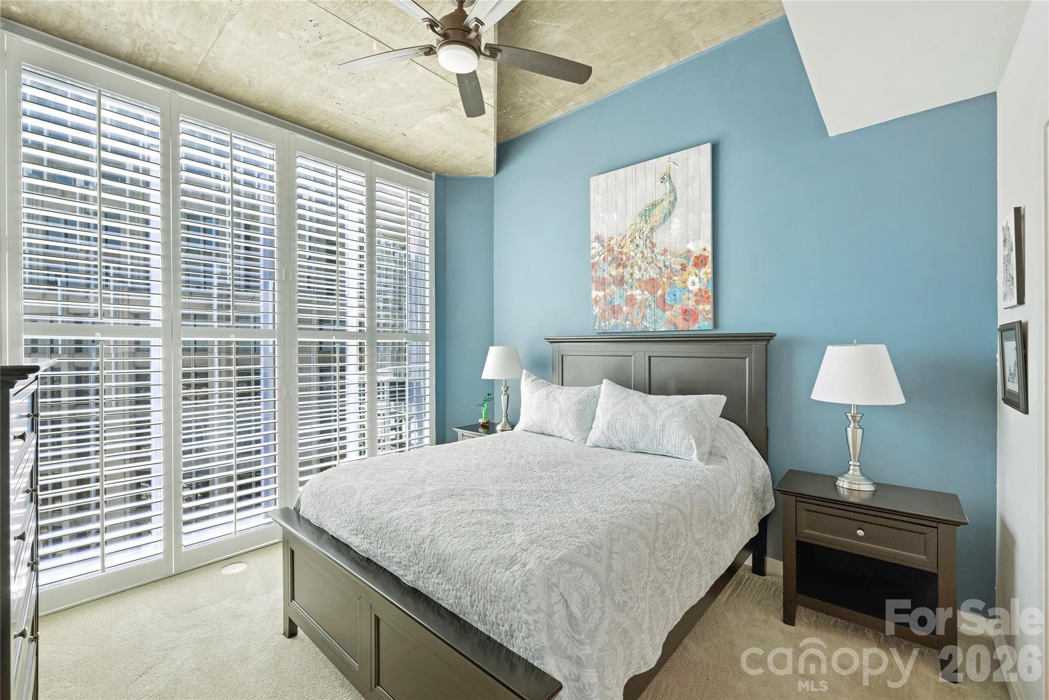 Primary bedroom with plantation shutters and skyline views - 210 N Church Street, Charlotte
