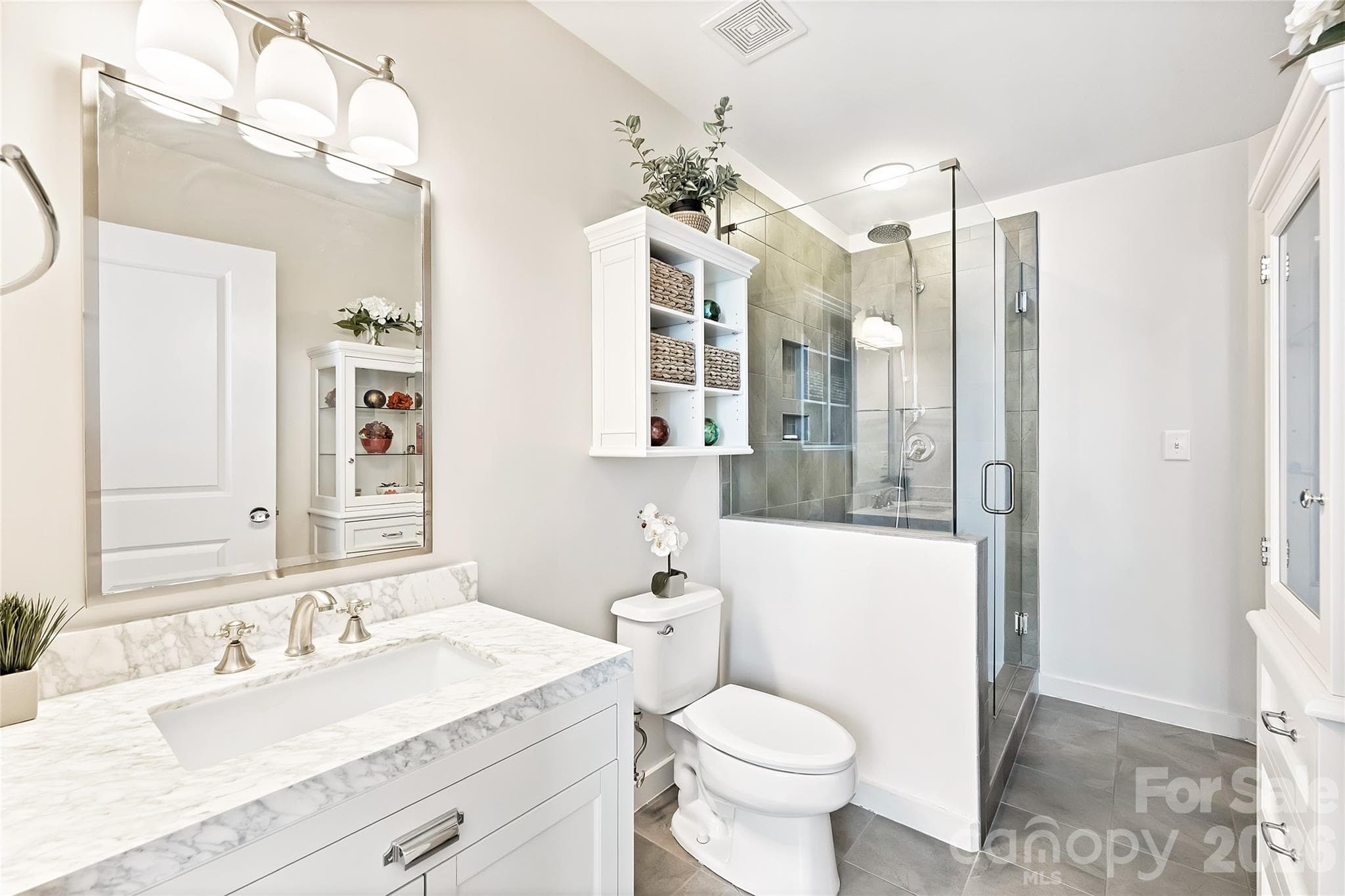 Renovated primary bath with updated vanity, tile and fixtures - 210 N Church Street, Charlotte