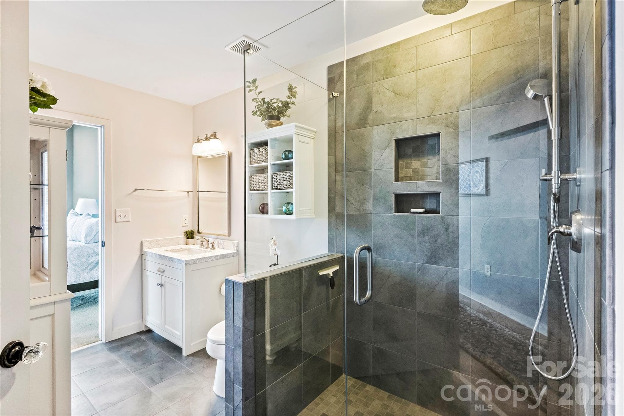 Renovated primary shower with upgraded tile and glass enclosure - 210 N Church Street, Charlotte