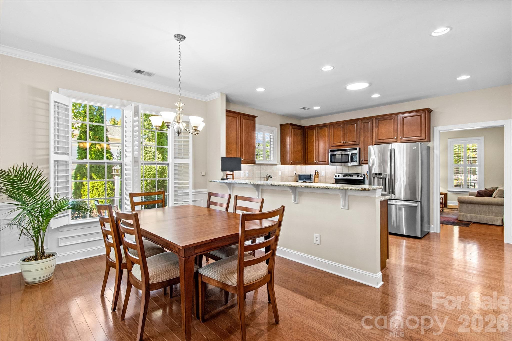 Owner loves to sit at the table with the plantation shutters open admiring the peaceful greenscape. - 18114 Ebenezer Drive, Cornelius