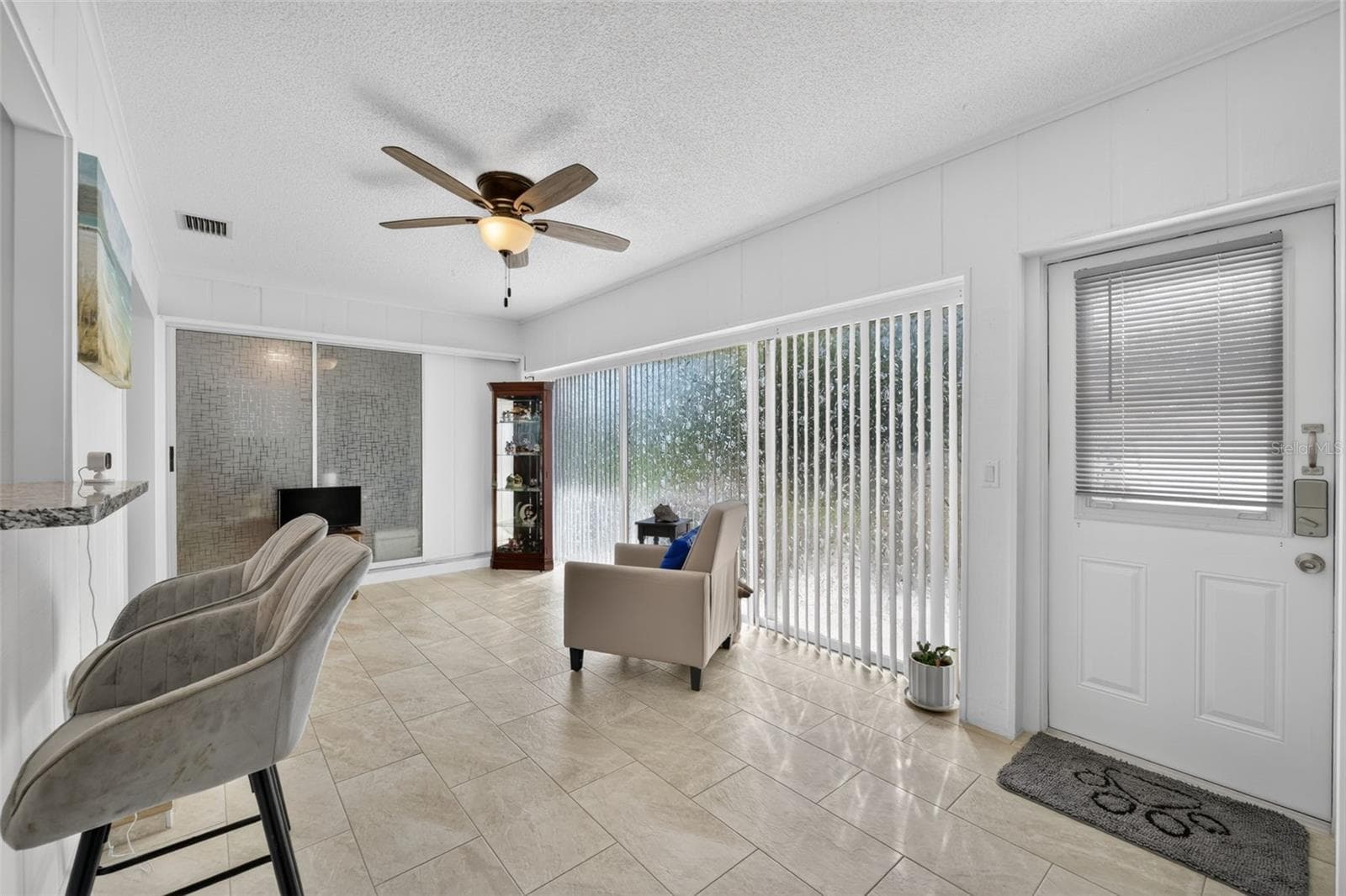 Family room with slider doors and door leading to patio - 82 CIRCLEWOOD DR #A3-4, VENICE
