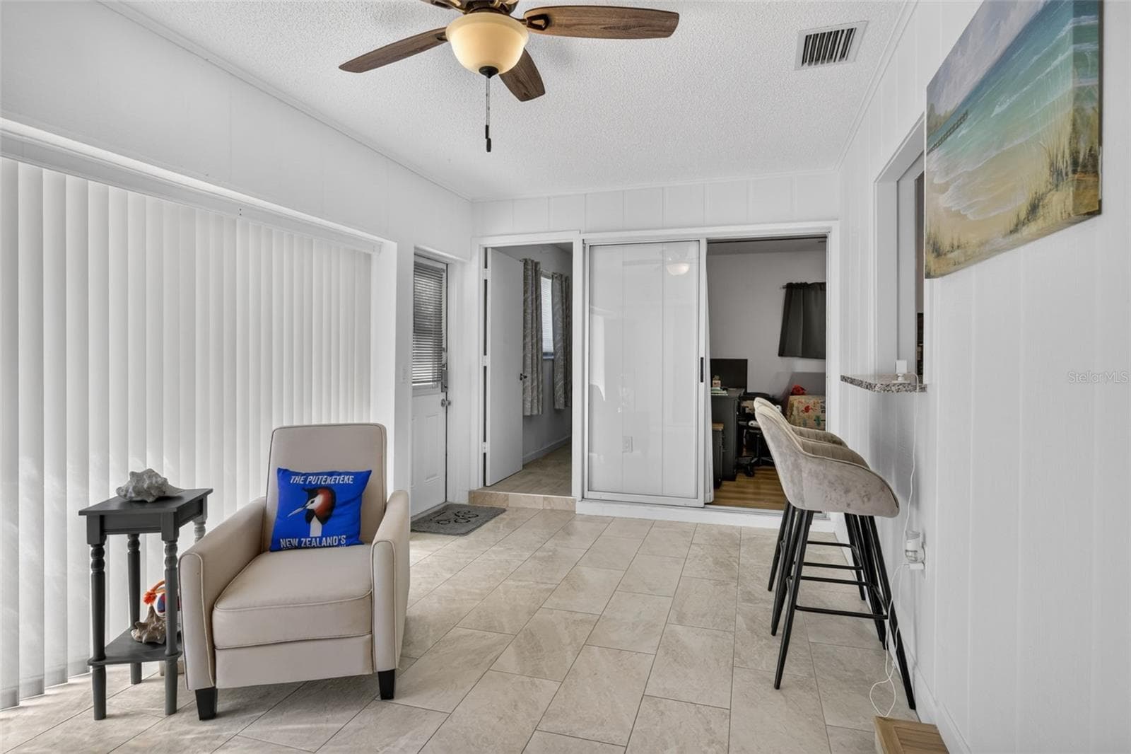 Family room with bar stools at a counter that looks through to kitchen - 82 CIRCLEWOOD DR #A3-4, VENICE