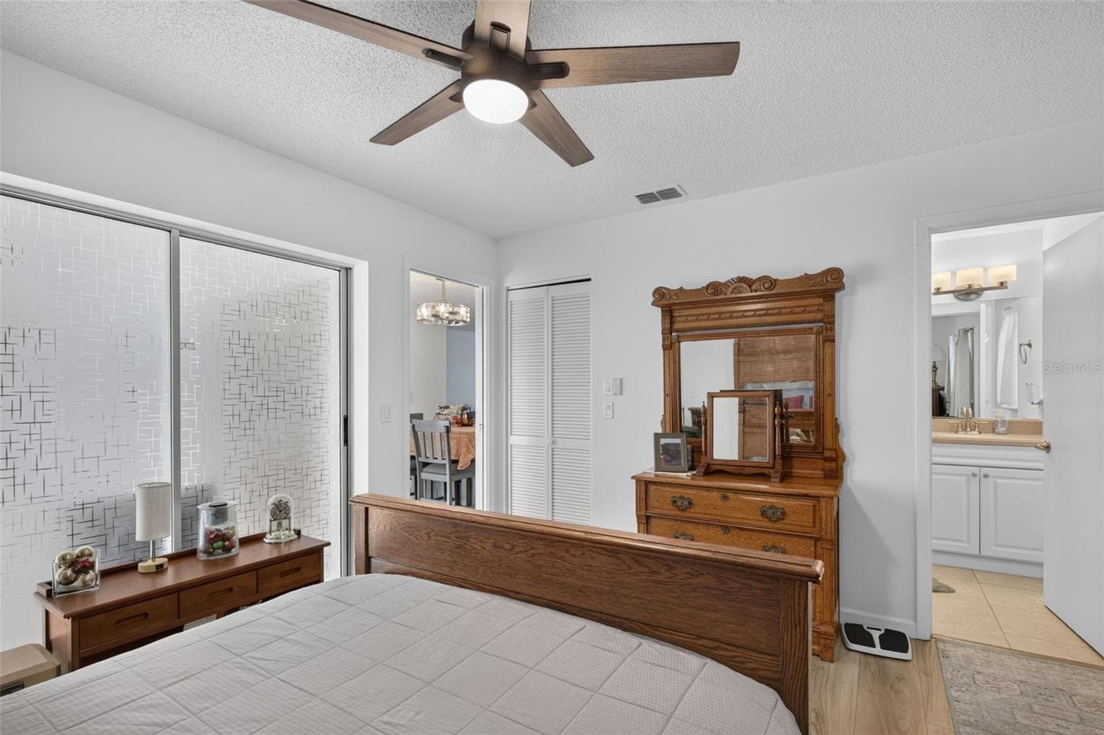Primary bedroom showing closet and en suite bathroom - 82 CIRCLEWOOD DR #A3-4, VENICE