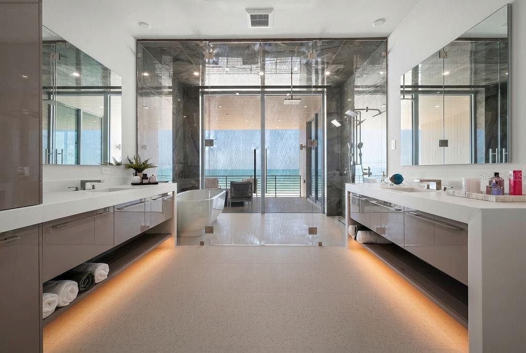 Primary bathroom has dual sinks, a dedicated vanity/ makeup area, and a wet room - 6489 GULFSIDE RD, LONGBOAT KEY