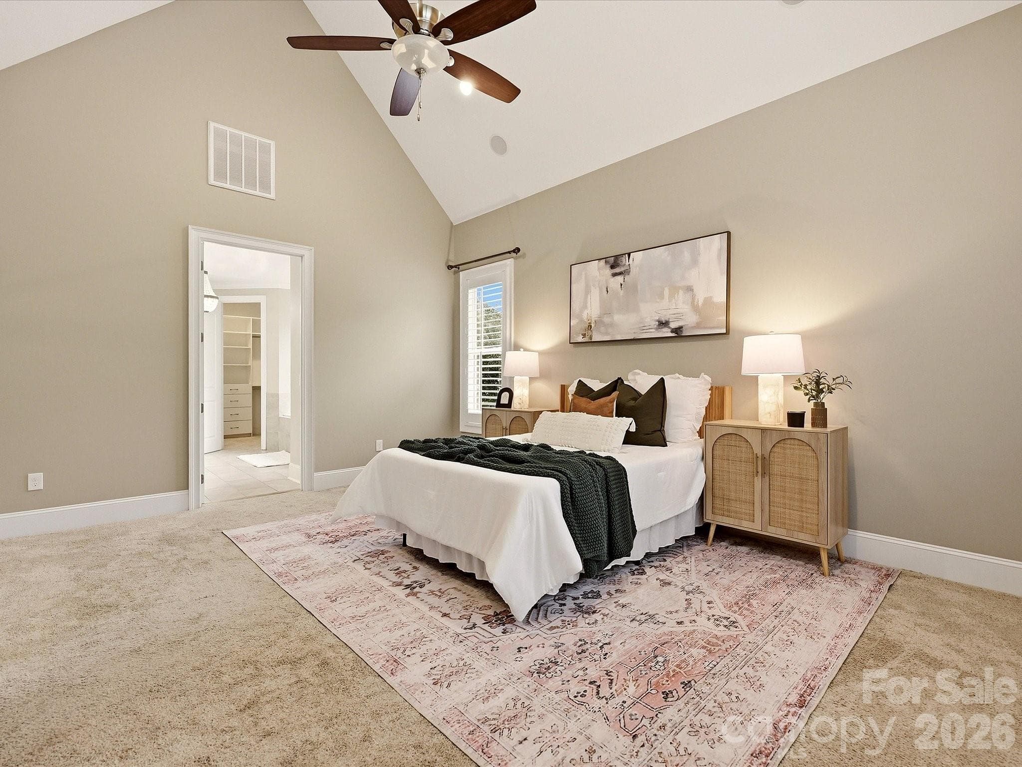 A spacious Primary Suite offers vaulted ceilings, abundant natural light, plantation shutters, plush carpeting, and direct access to the ensuite bath and walk-in closet. - 3167 James Plantation Drive, Denver