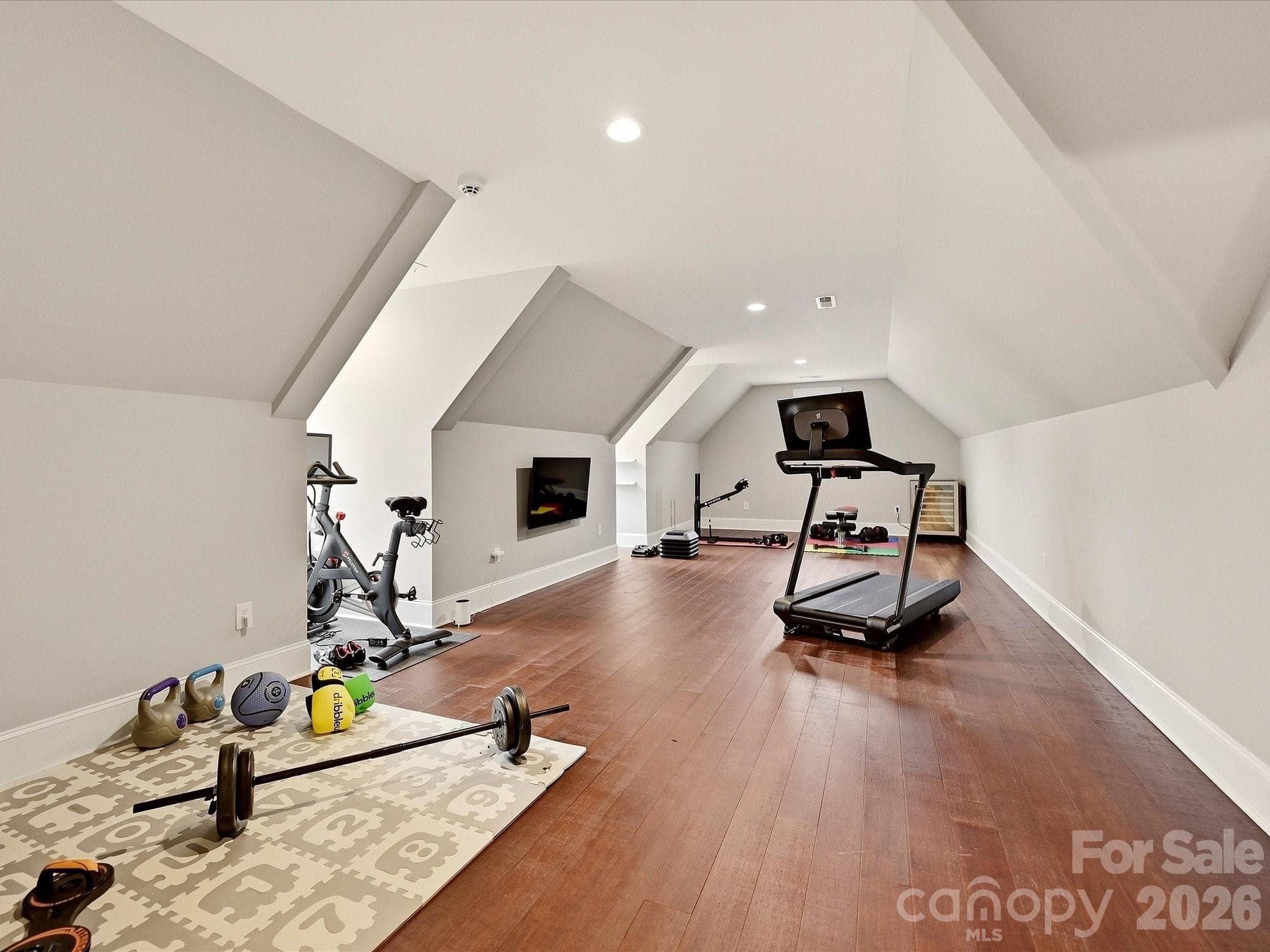 A spacious Bonus Room offers rich floors, recessed lighting, and flexible space ideal for a home gym, media room, game room, or additional living area. - 3167 James Plantation Drive, Denver