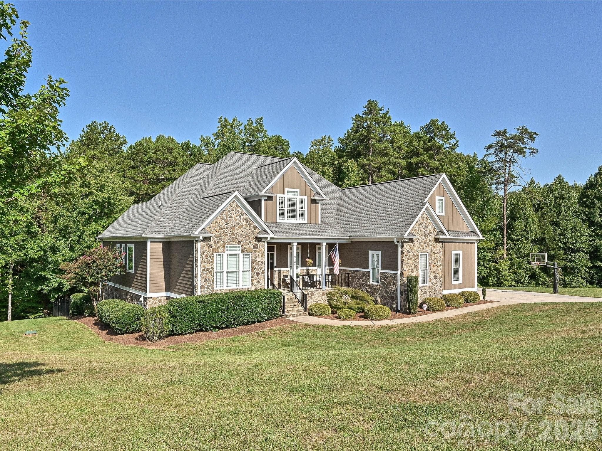 Wide views showcase the home’s impressive setting on a spacious homesite surrounded by mature trees, expansive lawn, and a peaceful residential backdrop. - 3167 James Plantation Drive, Denver