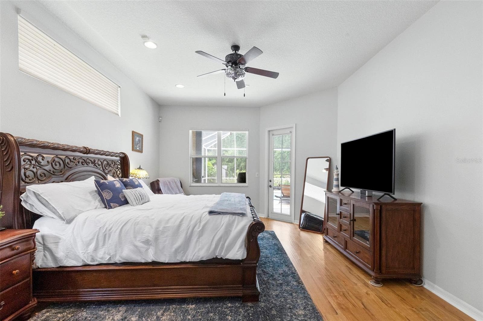 Primary bedroom with door leading out to lanai - 8380 GOLDEN PRAIRIE DR, TAMPA