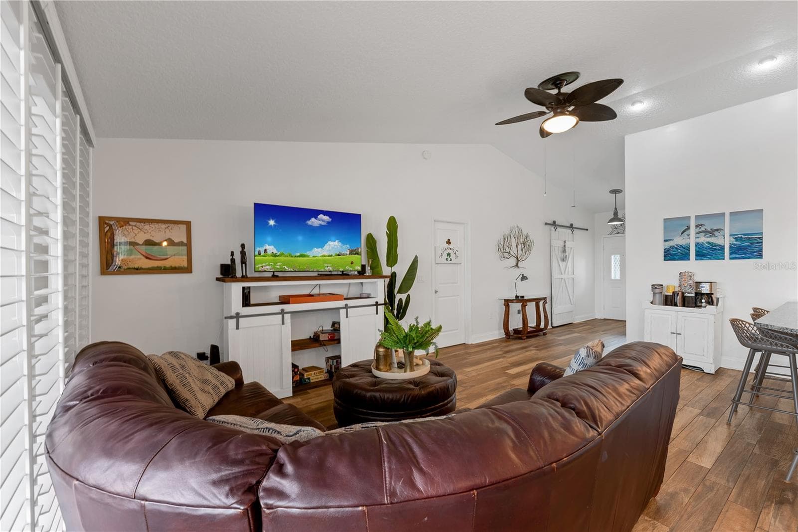 The door to the Owner's suite is off the Living room and the sliding barn door in the foyer conceals a coat closet and additional storage. - 743 KINGSTON CT, APOLLO BEACH