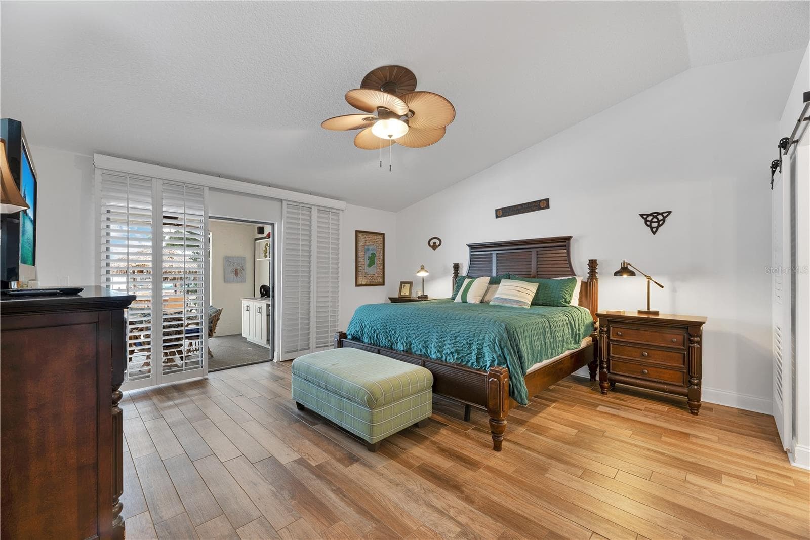 The Primary Suite features sliders to the lania, a large walk-in closet and beautifully appointed bathroom. - 743 KINGSTON CT, APOLLO BEACH