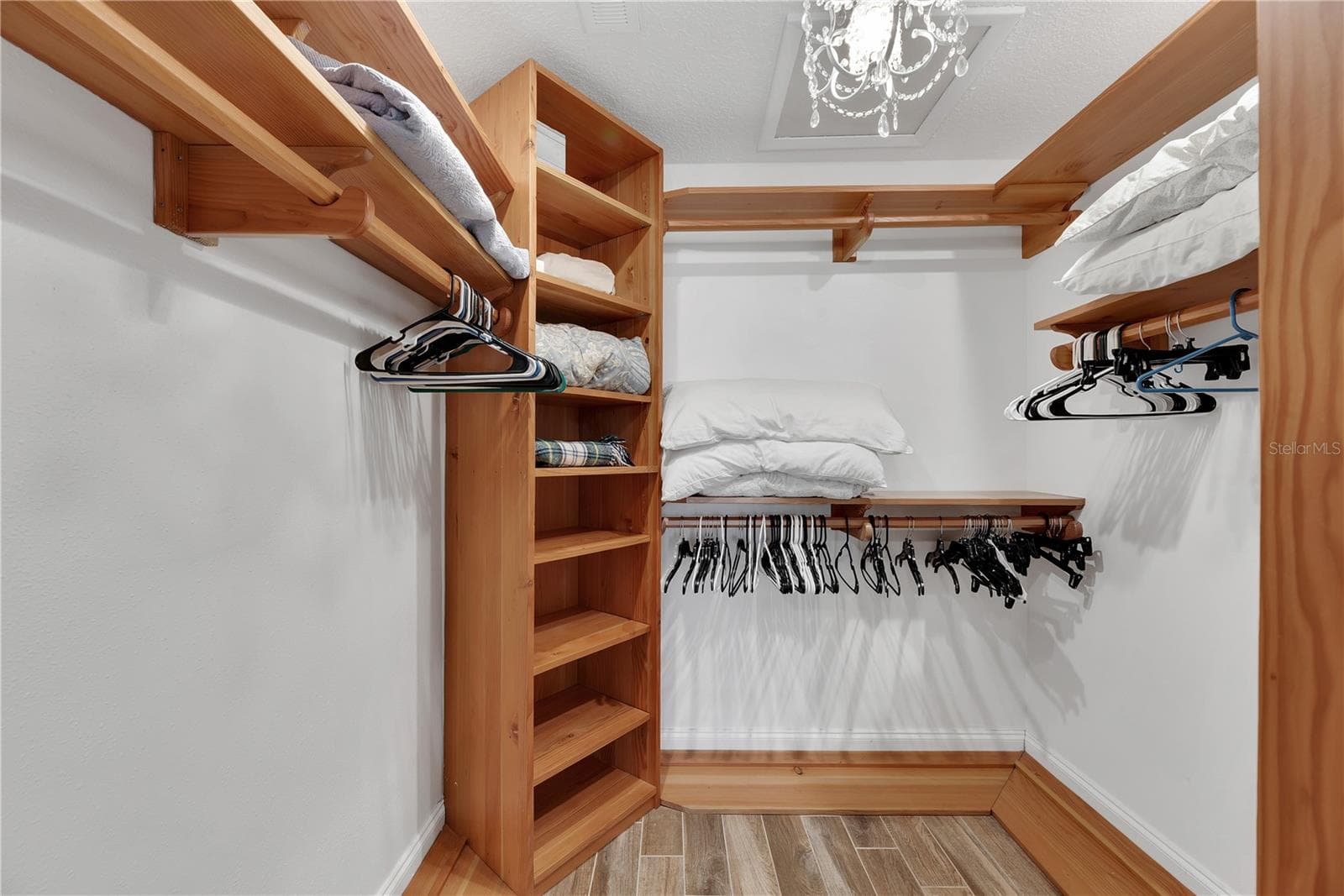 Spacious walk-in closet with custom built shelves and shoe storage. - 743 KINGSTON CT, APOLLO BEACH