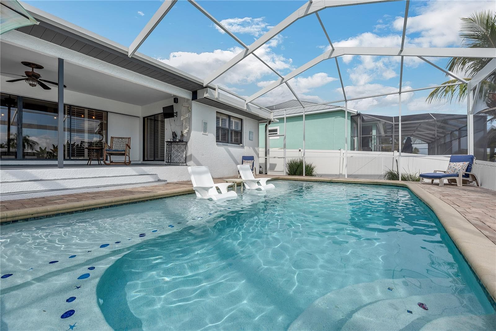 You will love this heated saltwater pool with a large shallow sun shelf for young kids and lounging. - 743 KINGSTON CT, APOLLO BEACH