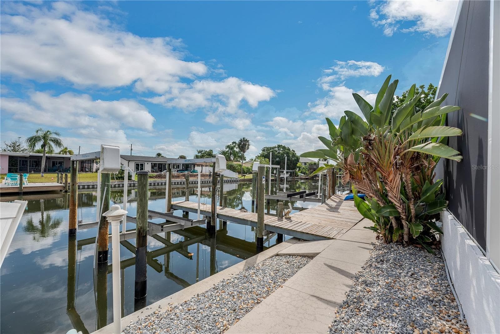 Boating enthusiasts will appreciate two private docks with 10,000- and 16,000-pound boat lifts, offering deep-water, bridge-free access to Tampa Bay. - 743 KINGSTON CT, APOLLO BEACH