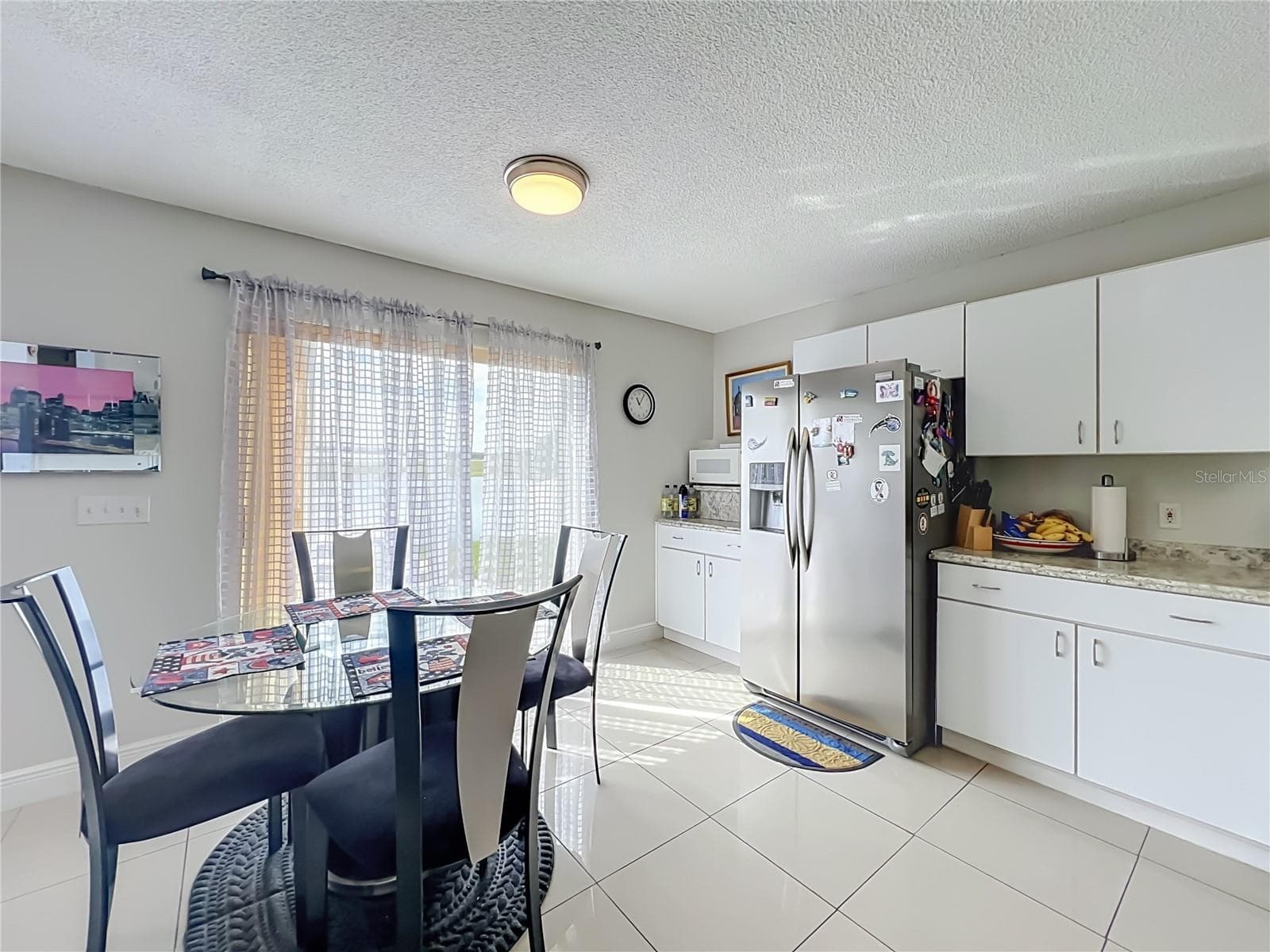 Dinette area in kitchen with sliding doors to the back yard and pond front - 12900 LOS ALAMITOS CT, ORLANDO
