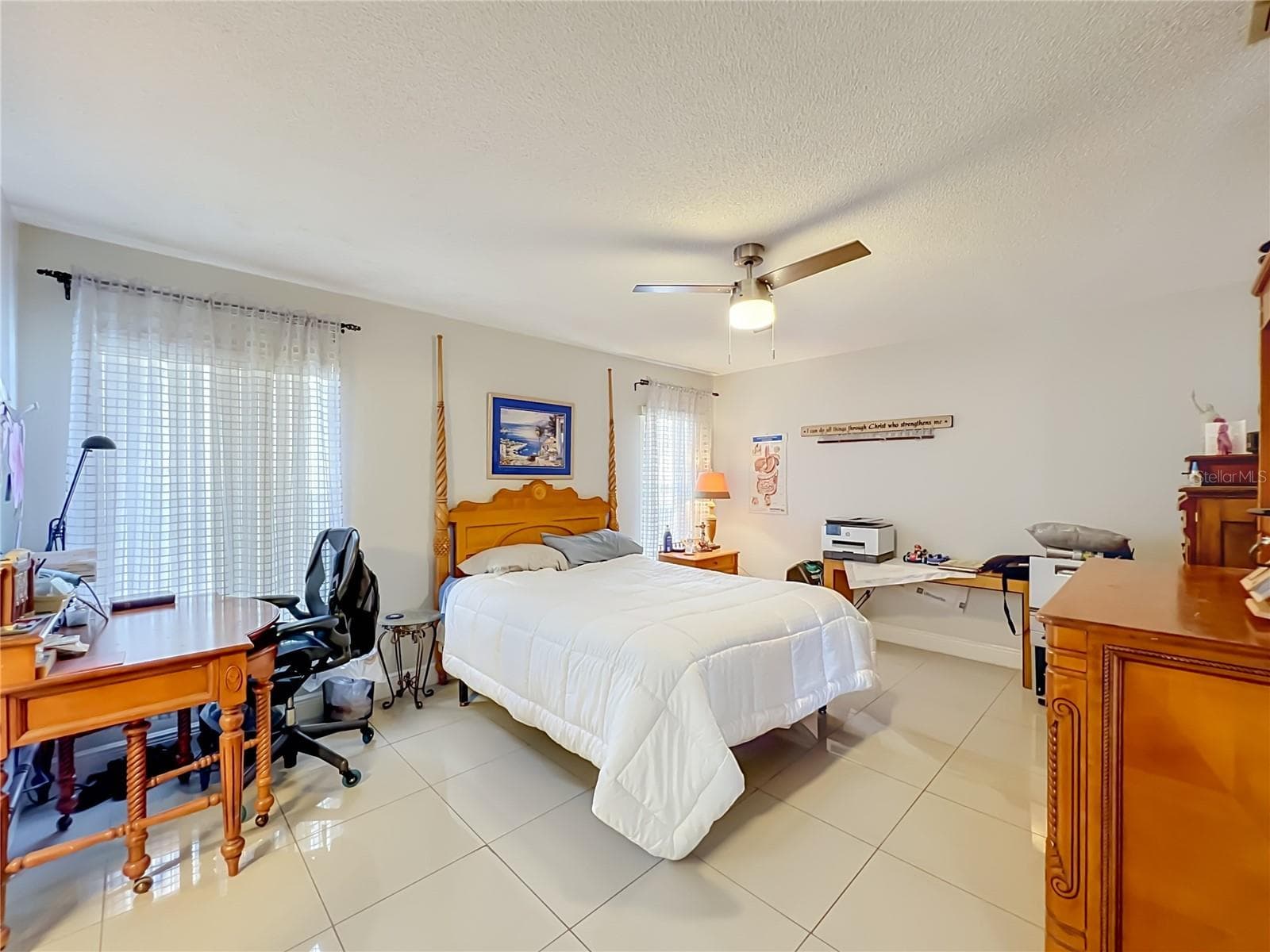Primary bedroom on 1st floor with ceiling fan and ceramic tile floor - 12900 LOS ALAMITOS CT, ORLANDO