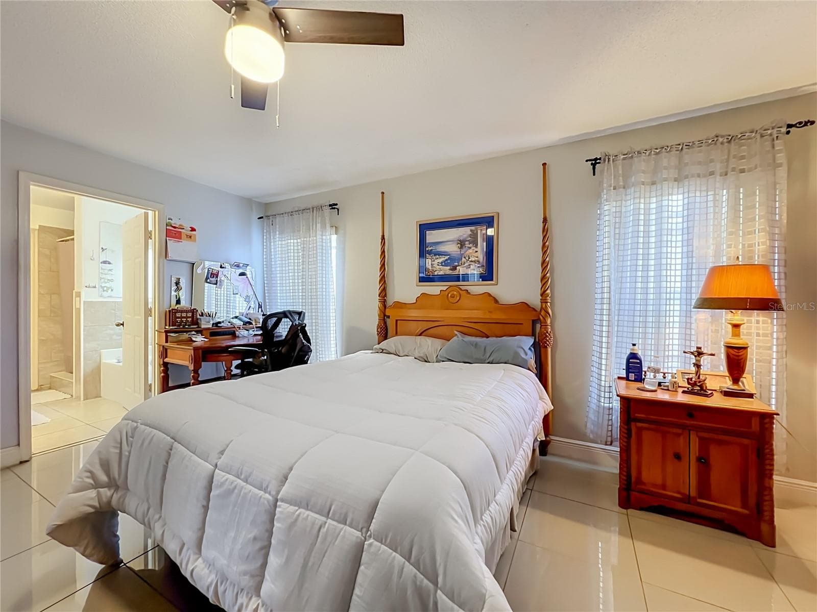 Primary bedroom on 1st floor with ceiling fan and ceramic tile floor - 12900 LOS ALAMITOS CT, ORLANDO
