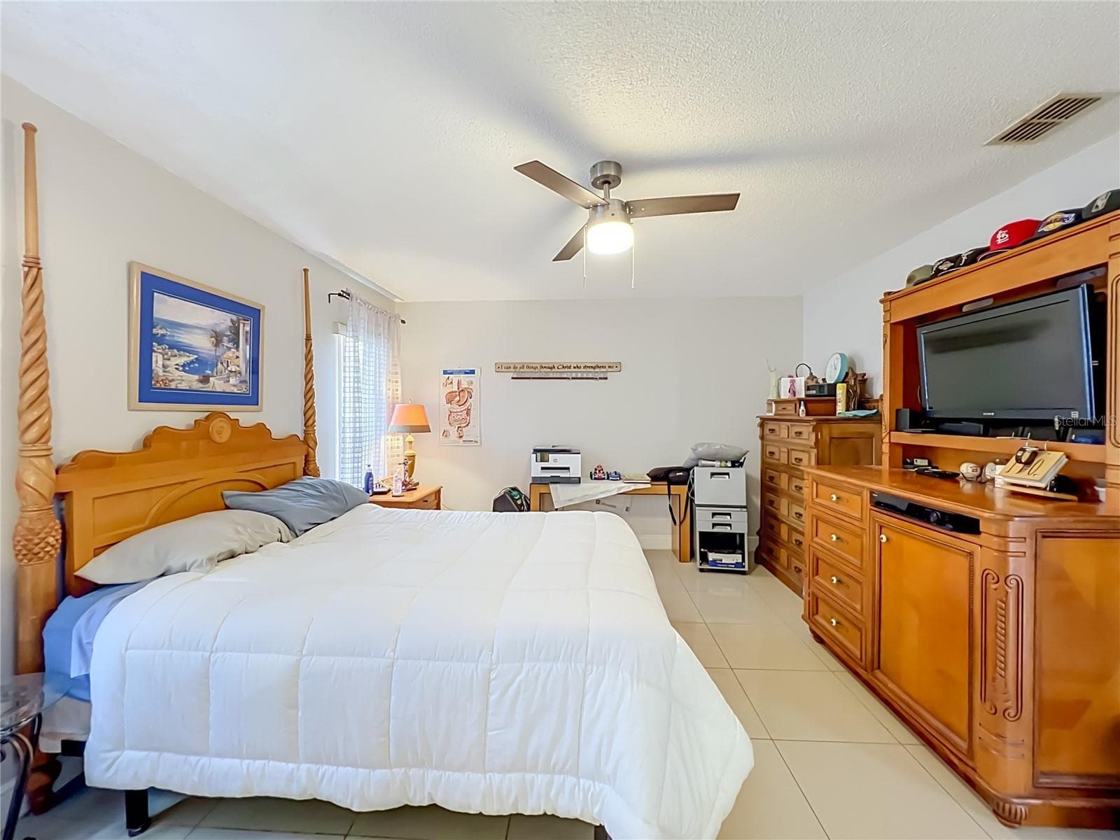 Primary bedroom on 1st floor with ceiling fan and ceramic tile floor - 12900 LOS ALAMITOS CT, ORLANDO