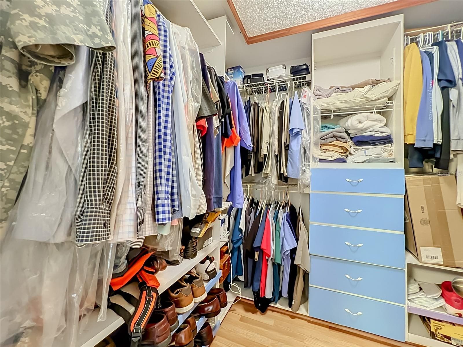 Wood floors and built in drawers and shelving in the large walk in Primary closet - 12900 LOS ALAMITOS CT, ORLANDO