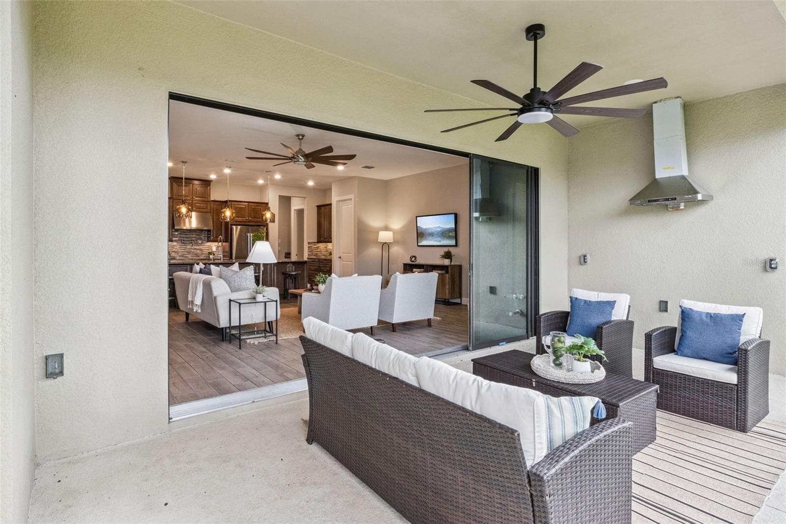 Covered patio with ceiling fan flowing into the open living area, perfect for enjoying Central Florida's year round sunshine. - 4108 VIA TOLEDO CT, POINCIANA