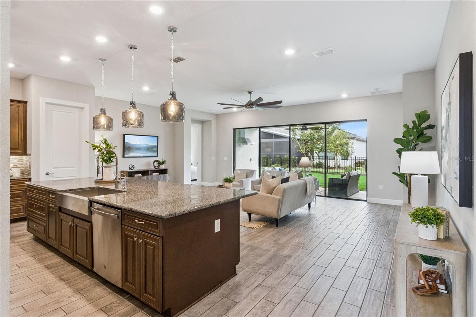 Kitchen island with pendant lighting and ample workspace overlooking the family room and patio. - 4108 VIA TOLEDO CT, POINCIANA