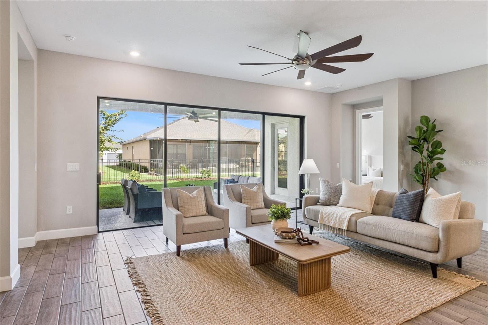 Family room with sliding glass doors opening to the private fenced patio. - 4108 VIA TOLEDO CT, POINCIANA