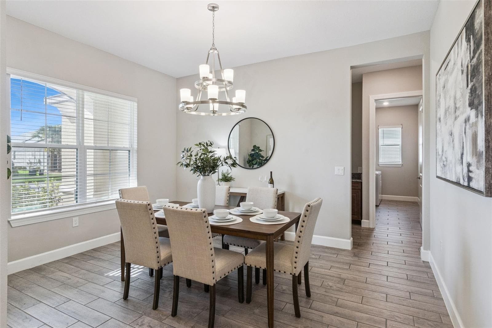 Separate dining room with chandelier, a dedicated setting for holidays and gatherings. - 4108 VIA TOLEDO CT, POINCIANA