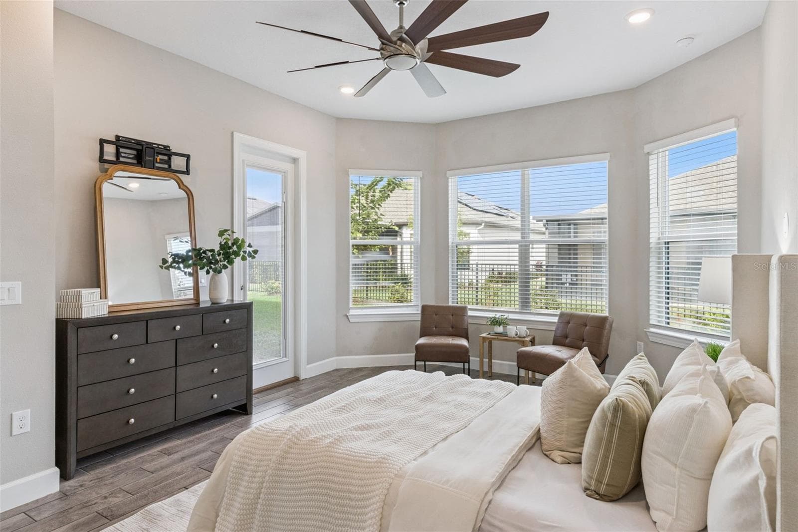 First primary suite with bay window sitting area, ceiling fan, and room for a king bed. - 4108 VIA TOLEDO CT, POINCIANA