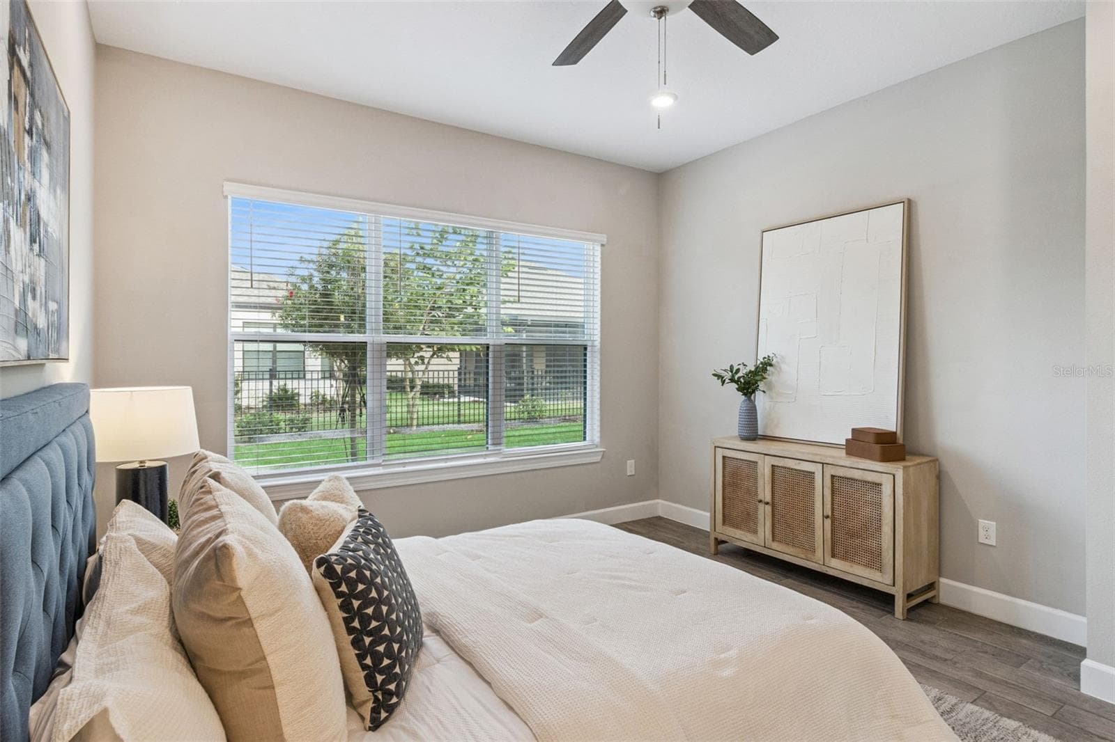 Second primary bedroom with natural light and peaceful neighborhood views. - 4108 VIA TOLEDO CT, POINCIANA