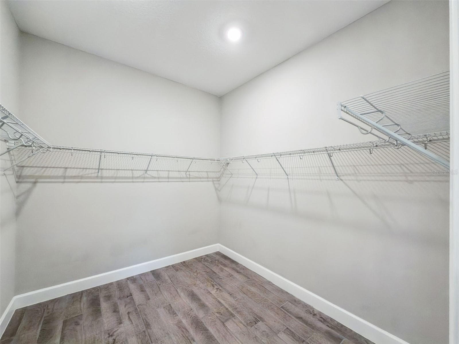 Walk in closet in the second primary suite with shelving and hanging space. - 4108 VIA TOLEDO CT, POINCIANA