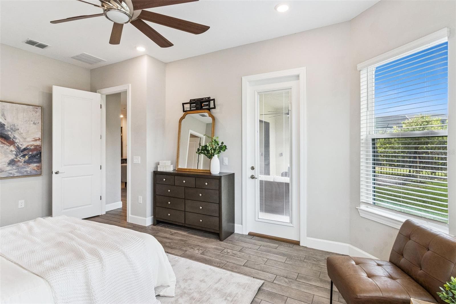 First primary bedroom with ceiling fan and window views. - 4108 VIA TOLEDO CT, POINCIANA